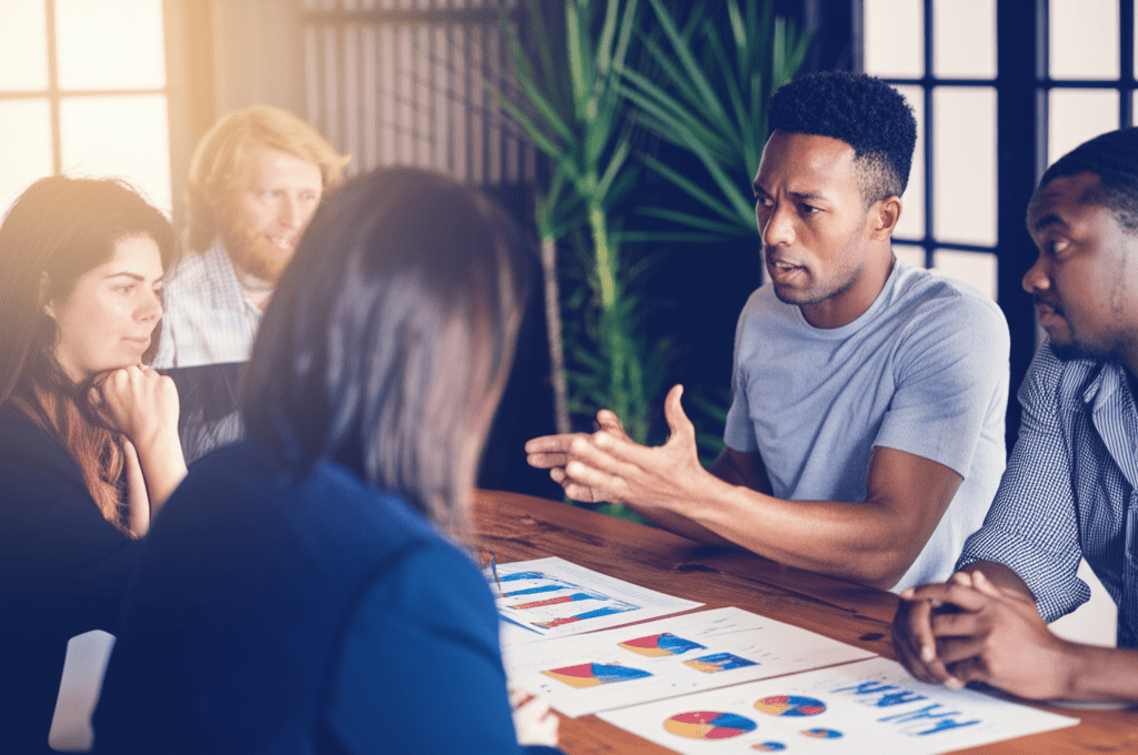 A professional business meeting scene showing diverse startup founders and a fractional CTO discussing technology strategy and rates, with a modern office background symbolizing negotiation and collaboration in the tech industry