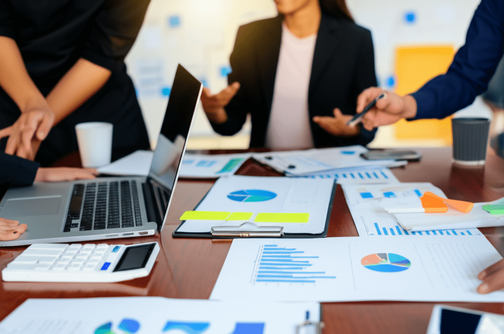 A professional and modern office setting with a diverse group of startup founders and a fractional CTO discussing equity compensation models, with charts and laptops visible, symbolizing negotiation and strategy in a tech startup environment