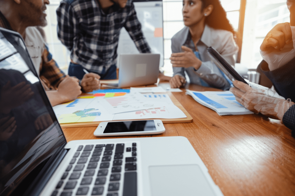 A professional business meeting scene with diverse startup founders and a fractional CTO discussing technology strategy in a modern office environment