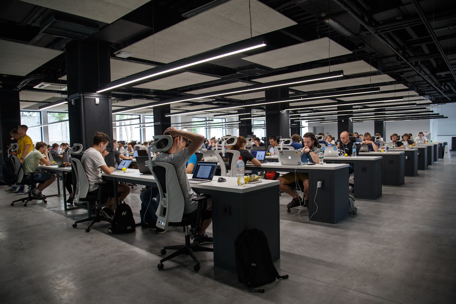 Diverse tech team collaborating in a modern office with a leader guiding them, symbolizing fractional CTO leadership and recruitment in UK SMEs.